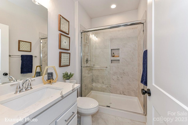 bathroom with walk in shower, tile flooring, large vanity, and toilet