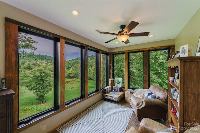 sunroom featuring ceiling fan