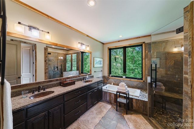 bathroom featuring crown molding, tile floors, dual sinks, separate shower and tub, and large vanity