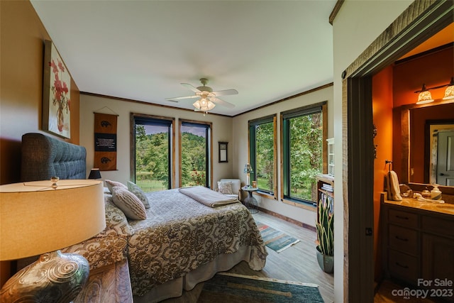 bedroom featuring light hardwood / wood-style floors, ornamental molding, and ceiling fan