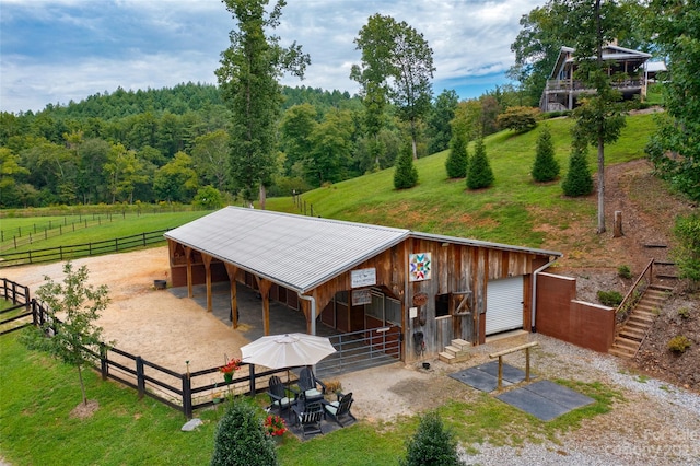 exterior space featuring an outdoor structure and a lawn