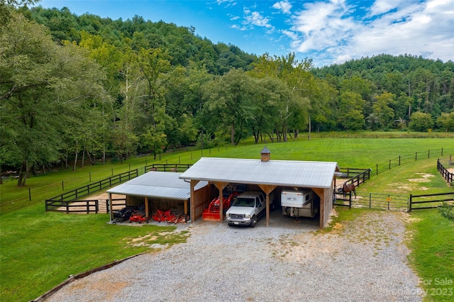 view of front of home featuring a rural view and a front lawn