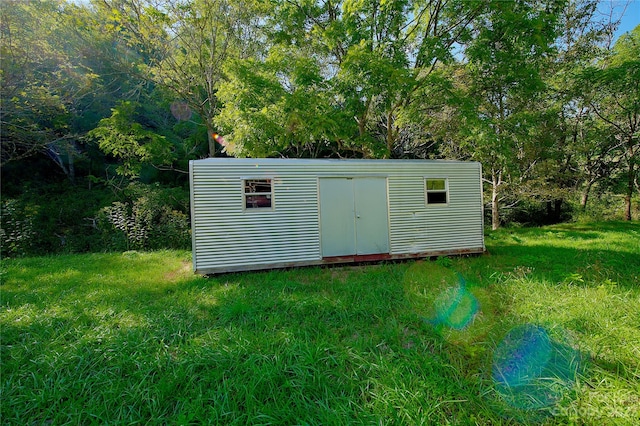 view of shed / structure featuring a yard