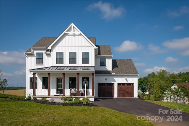 modern farmhouse featuring a front lawn and covered porch