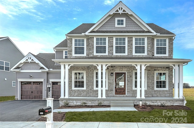 craftsman-style house featuring a porch and a garage