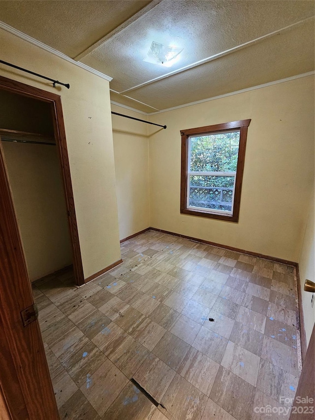 unfurnished bedroom featuring a textured ceiling and light tile floors