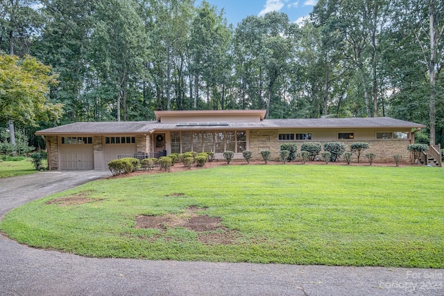 ranch-style home with a front yard and a garage