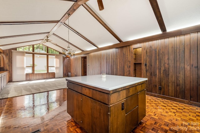 kitchen featuring a kitchen island, wooden walls, and parquet flooring