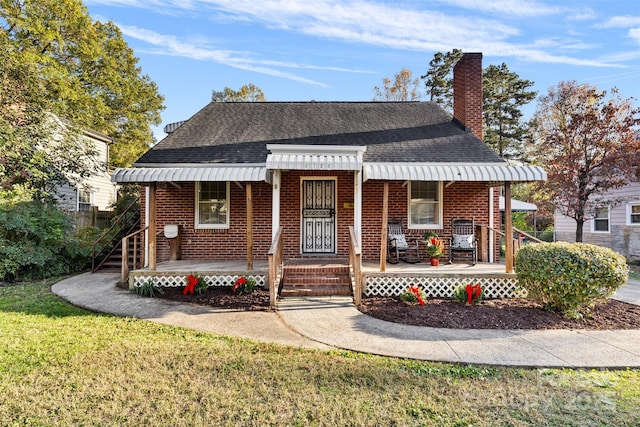 bungalow-style house with covered porch and a front yard