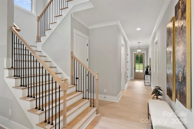 stairway with baseboards, recessed lighting, wood finished floors, and ornamental molding