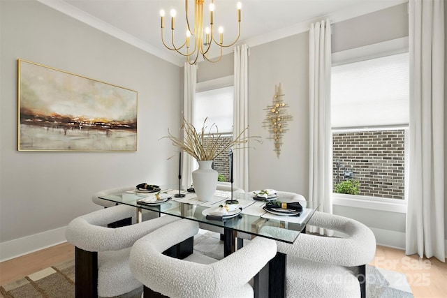 dining room with wood finished floors, a chandelier, a wealth of natural light, and ornamental molding