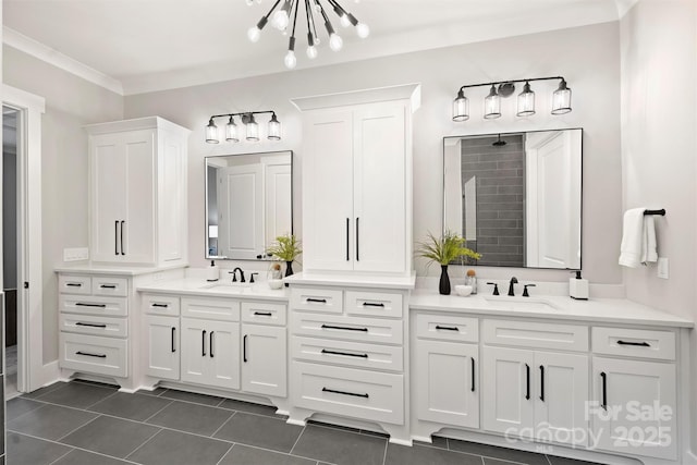 bathroom with tile patterned floors, two vanities, a notable chandelier, and a sink