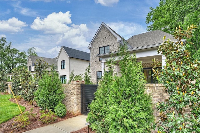 view of front of home with fence and brick siding