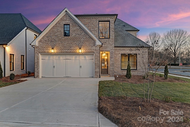 view of front of house with a yard and a garage