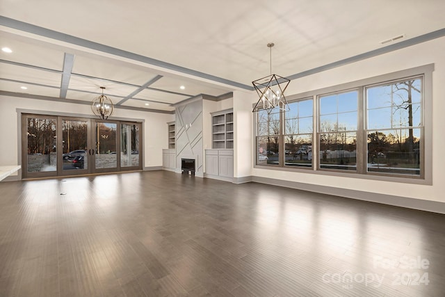 unfurnished living room featuring coffered ceiling, an inviting chandelier, and dark wood-type flooring