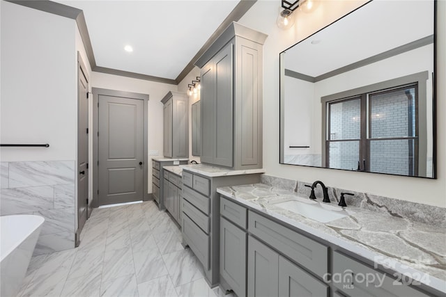 bathroom featuring tile floors, ornamental molding, a washtub, and oversized vanity