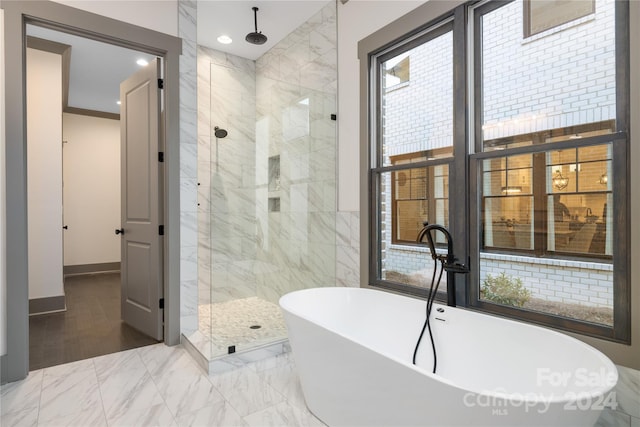 bathroom featuring tile walls, plus walk in shower, and hardwood / wood-style flooring