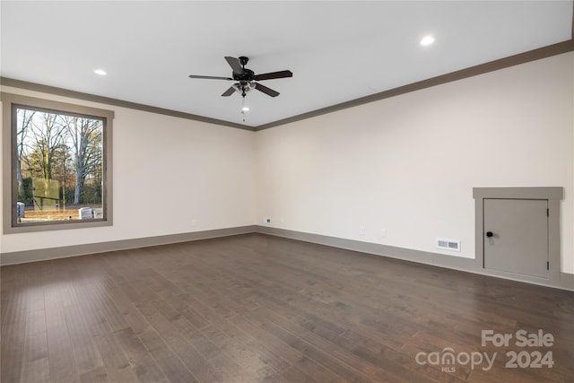 empty room featuring ceiling fan, crown molding, and dark hardwood / wood-style floors