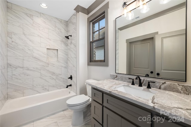 full bathroom featuring tiled shower / bath, toilet, large vanity, and tile flooring