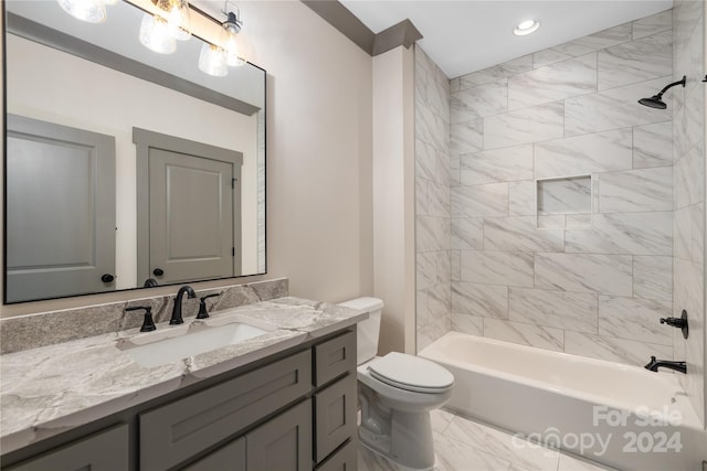 full bathroom with tile flooring, tiled shower / bath, toilet, and vanity with extensive cabinet space