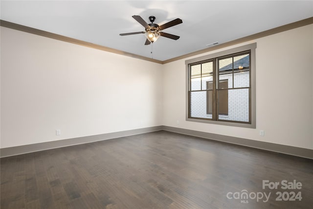 unfurnished room featuring ceiling fan, crown molding, and dark hardwood / wood-style floors