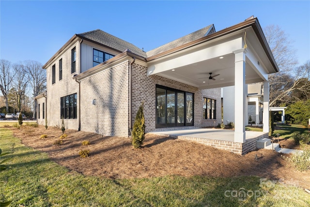 rear view of property with ceiling fan