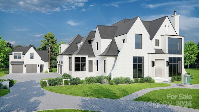 french country style house with a garage and a front yard