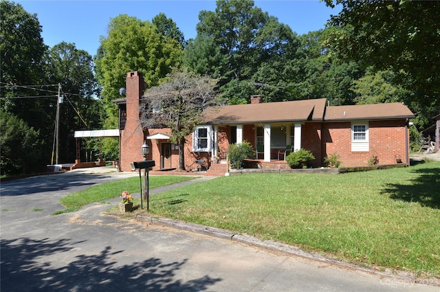 ranch-style home featuring a front yard