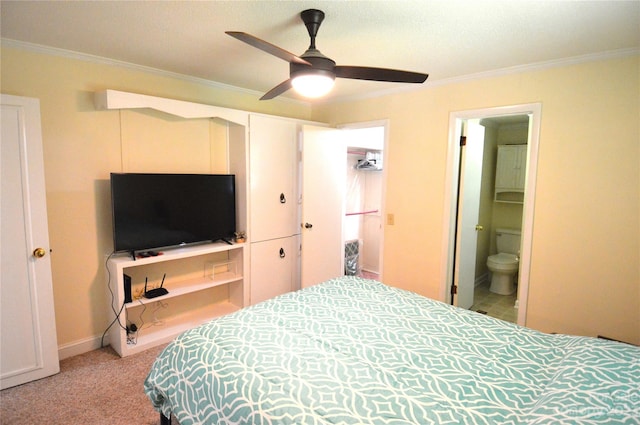 carpeted bedroom featuring ceiling fan, ensuite bathroom, and ornamental molding