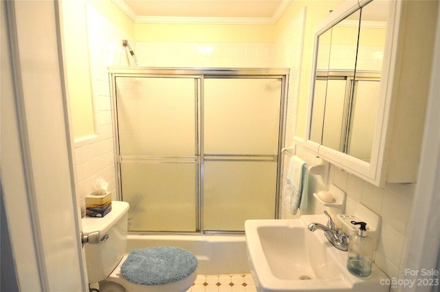 full bathroom featuring tile walls, shower / bath combination with glass door, toilet, and tile floors