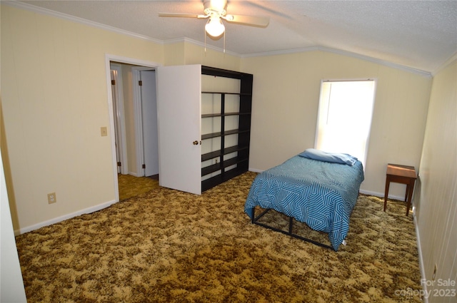 carpeted bedroom with ceiling fan, a textured ceiling, ornamental molding, and vaulted ceiling