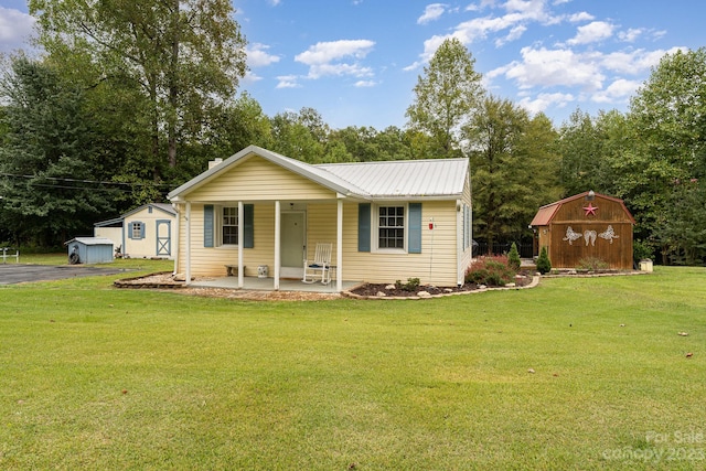 ranch-style home with a front lawn and a storage shed