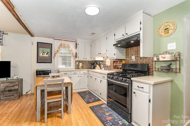 kitchen featuring backsplash, sink, light hardwood / wood-style flooring, black gas range oven, and white cabinets