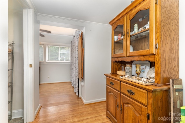 corridor with crown molding and light hardwood / wood-style flooring