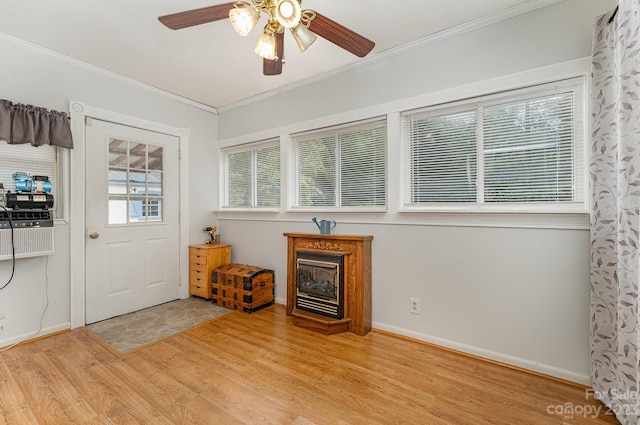 entrance foyer with crown molding, ceiling fan, and light wood-type flooring