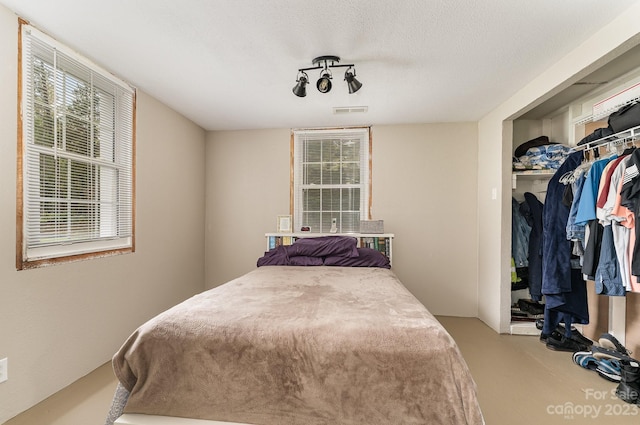 bedroom featuring a closet and a textured ceiling