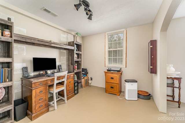 office space featuring light colored carpet and a textured ceiling