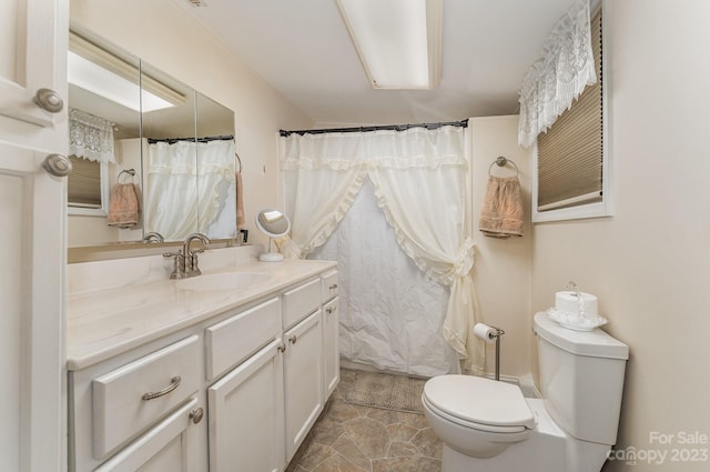 bathroom featuring vanity, tile floors, and toilet