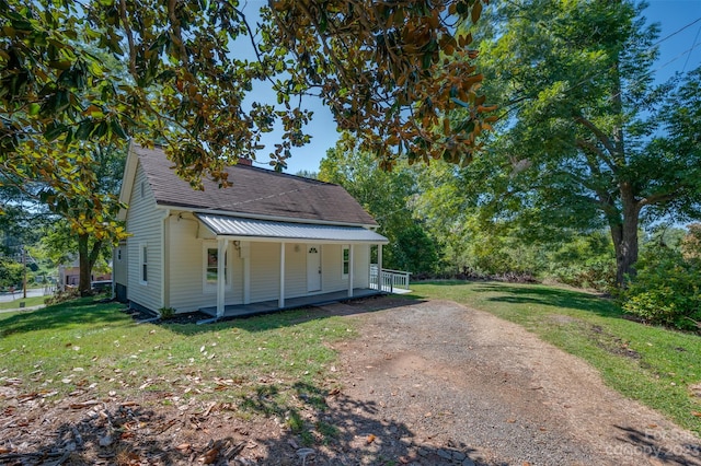 exterior space featuring a lawn and covered porch