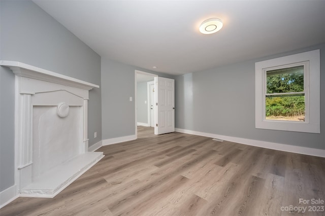 unfurnished living room featuring light wood-type flooring