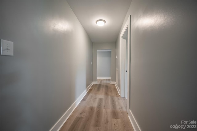 corridor with light hardwood / wood-style flooring