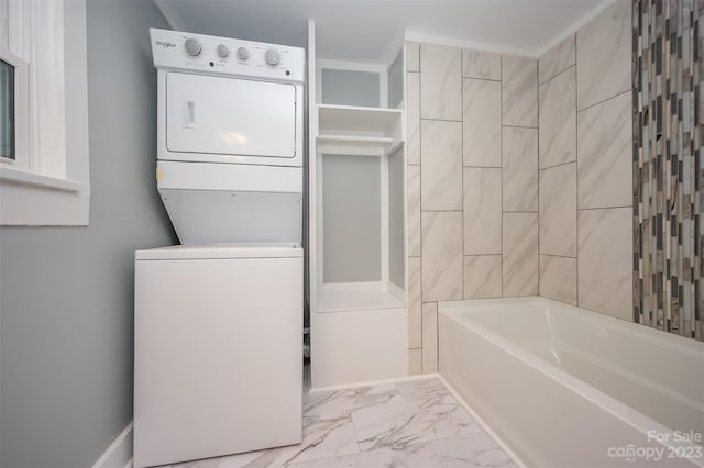 laundry room with light tile floors and stacked washing maching and dryer