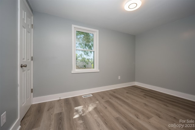 unfurnished room with dark wood-type flooring