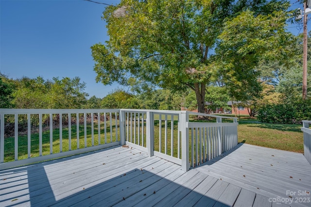 wooden deck with a lawn