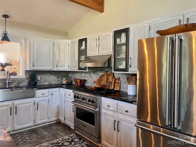 kitchen with tasteful backsplash, dark tile flooring, high end appliances, wall chimney exhaust hood, and lofted ceiling with beams