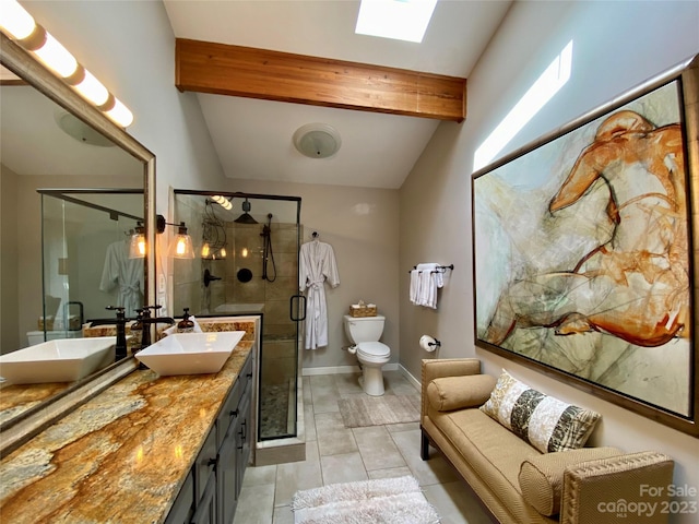 bathroom featuring vanity, tile floors, lofted ceiling with skylight, a shower with door, and toilet