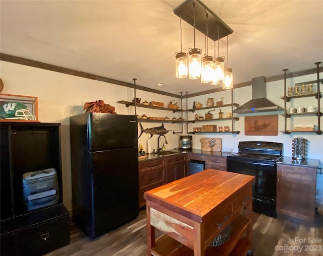 kitchen featuring decorative light fixtures, wall chimney exhaust hood, black appliances, dark hardwood / wood-style floors, and sink