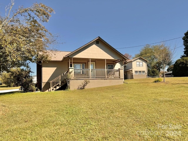 back of house with a yard and covered porch