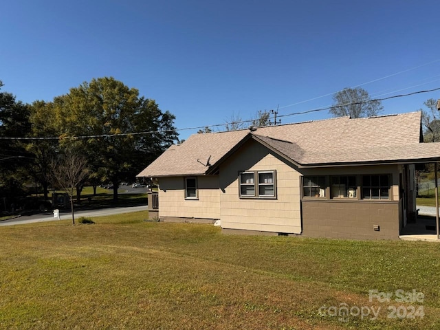 view of property exterior featuring a lawn