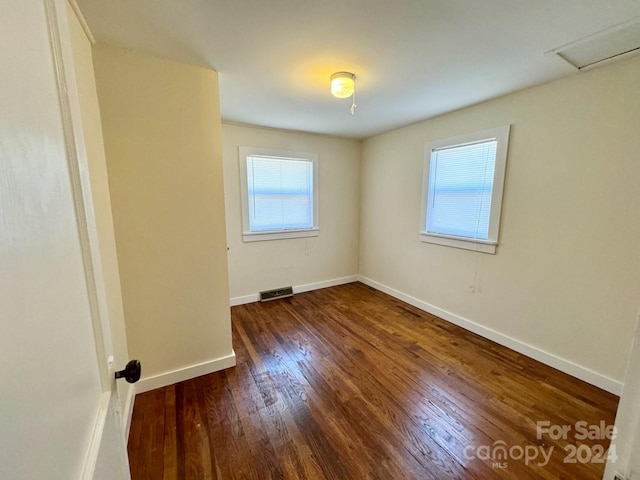 spare room with dark hardwood / wood-style flooring